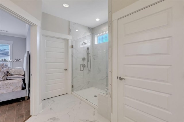 bathroom featuring a shower with door and ornamental molding