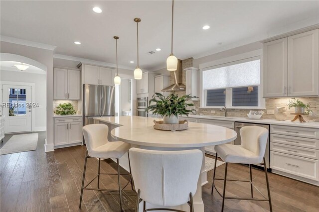 dining room with crown molding, sink, and dark hardwood / wood-style floors