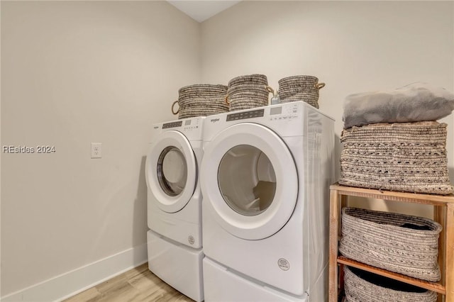 washroom with separate washer and dryer and light wood-type flooring