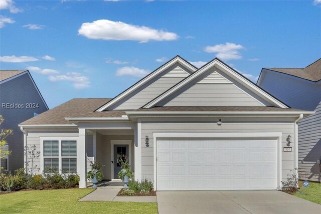 view of front of house featuring a garage and a front lawn