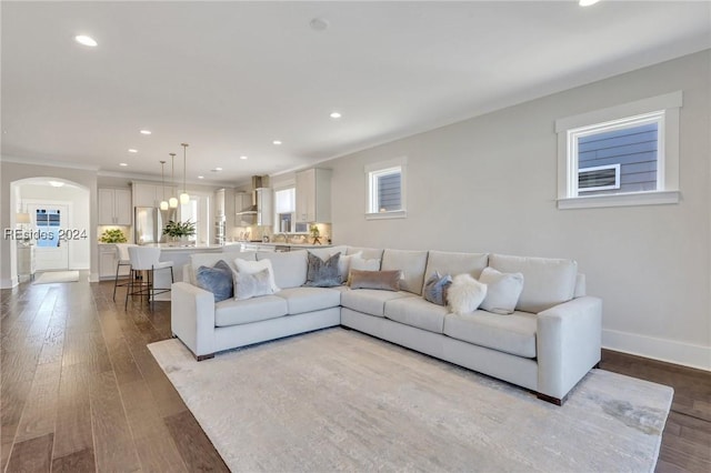 living room with ornamental molding and light wood-type flooring