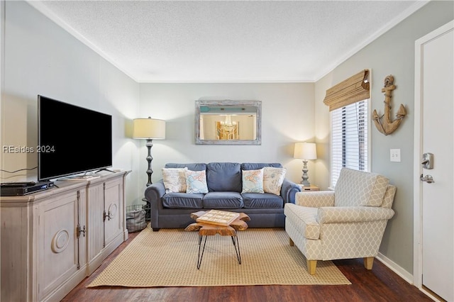 living room with ornamental molding, dark hardwood / wood-style floors, and a textured ceiling