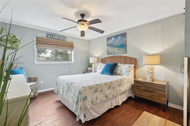 bedroom featuring dark hardwood / wood-style flooring, a textured ceiling, and ceiling fan