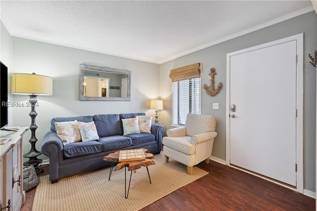 living room featuring dark hardwood / wood-style flooring, ornamental molding, and a textured ceiling