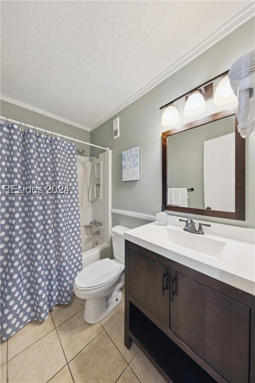 full bathroom with shower / tub combo with curtain, tile patterned floors, ornamental molding, and a textured ceiling