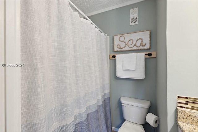 bathroom with a textured ceiling and toilet