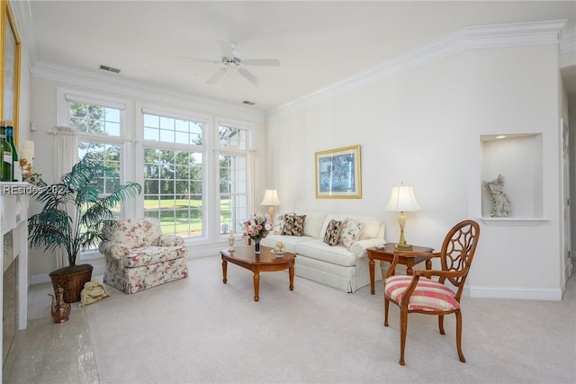 carpeted living room featuring ornamental molding and ceiling fan