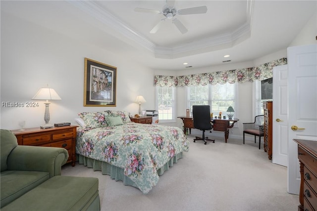 carpeted bedroom featuring a raised ceiling, crown molding, and ceiling fan