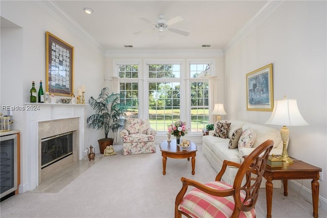 carpeted living room featuring a premium fireplace, crown molding, a healthy amount of sunlight, and beverage cooler