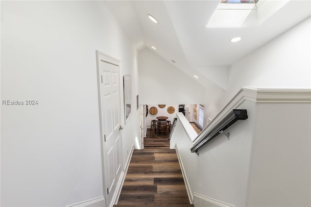 staircase with hardwood / wood-style floors and a skylight