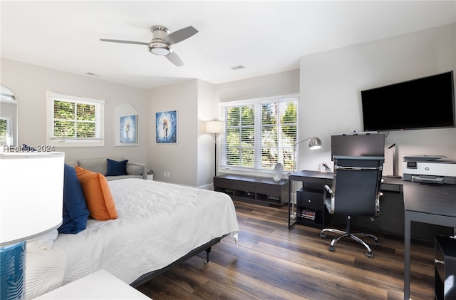 bedroom with dark wood-type flooring, ceiling fan, and multiple windows