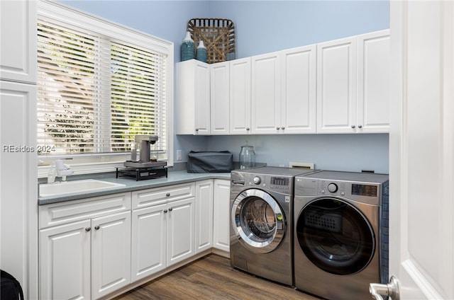 clothes washing area with dark hardwood / wood-style flooring, sink, cabinets, and washing machine and clothes dryer