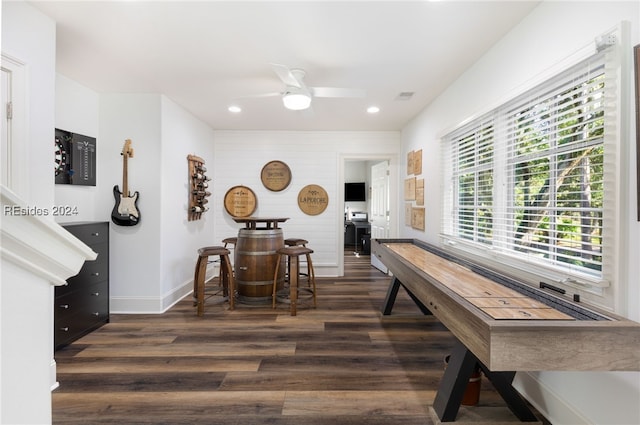 recreation room featuring ceiling fan and dark hardwood / wood-style flooring