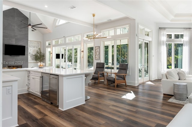 kitchen with white cabinetry, hanging light fixtures, dark hardwood / wood-style flooring, and plenty of natural light