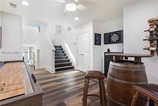 bar featuring dark hardwood / wood-style floors and ceiling fan