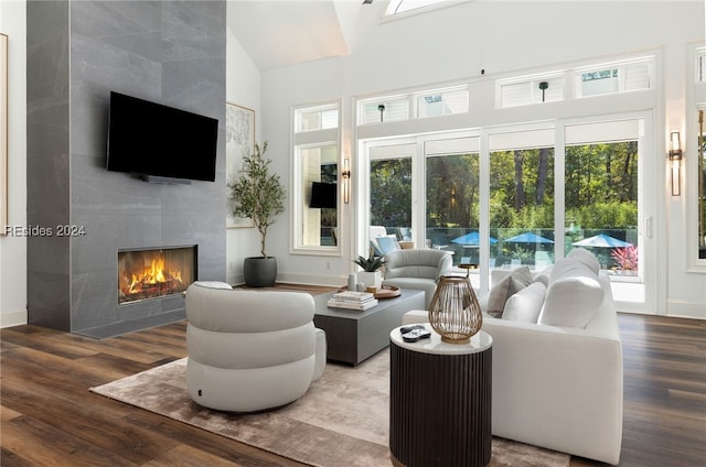 living room with lofted ceiling, a premium fireplace, and hardwood / wood-style floors