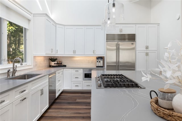 kitchen featuring stainless steel appliances, sink, white cabinets, and backsplash