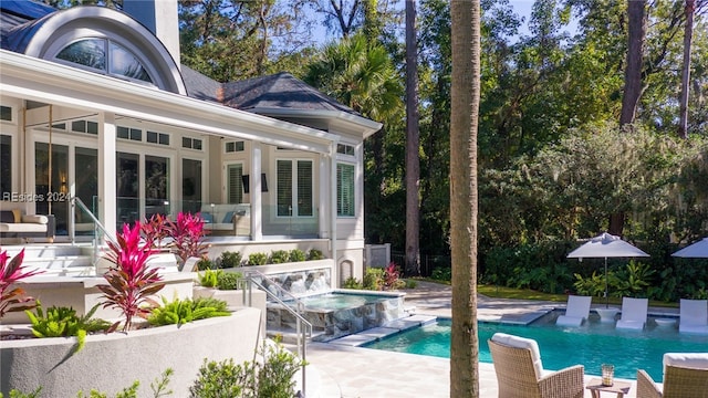 view of pool featuring a patio and an in ground hot tub