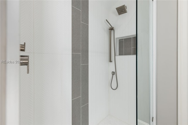 bathroom with tiled shower