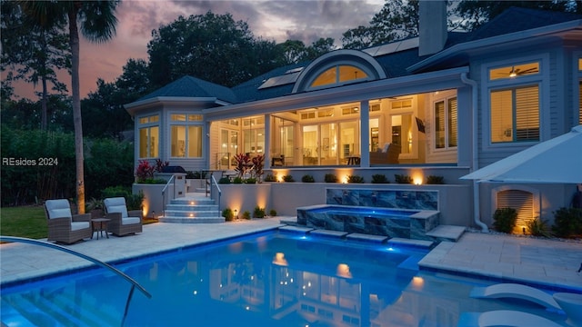 back house at dusk with a patio area