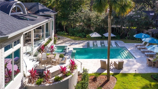 view of pool with a patio and an in ground hot tub