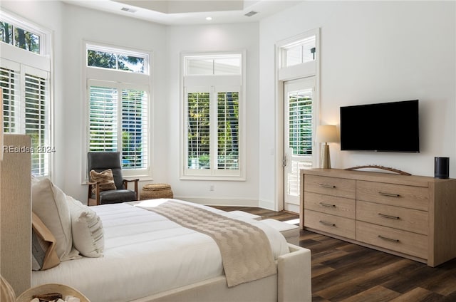 bedroom with dark wood-type flooring and a high ceiling