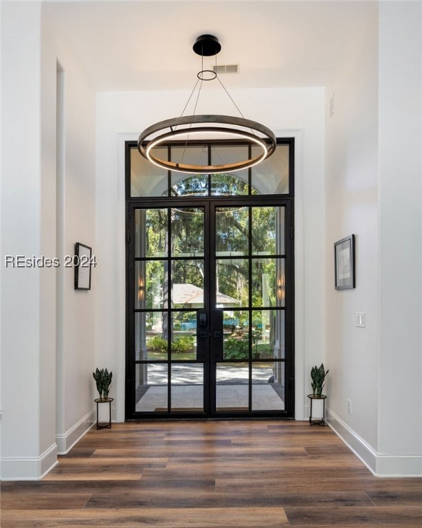 doorway to outside with dark hardwood / wood-style flooring and french doors