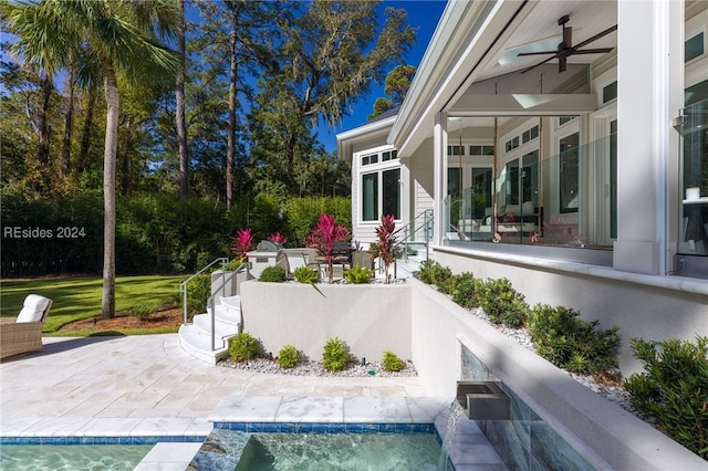 view of patio featuring ceiling fan