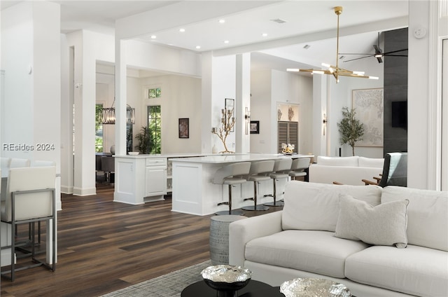 living room featuring beam ceiling, dark hardwood / wood-style floors, and a chandelier