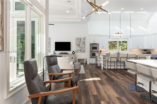 interior space featuring an inviting chandelier, dark hardwood / wood-style flooring, and a tray ceiling