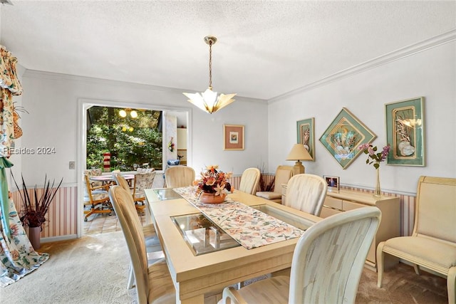 dining room with crown molding, light colored carpet, and a textured ceiling