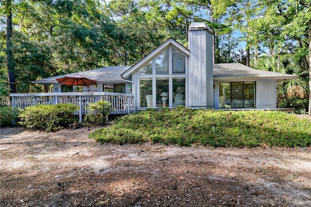 rear view of property with a wooden deck