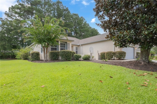 view of front of home with a garage and a front yard