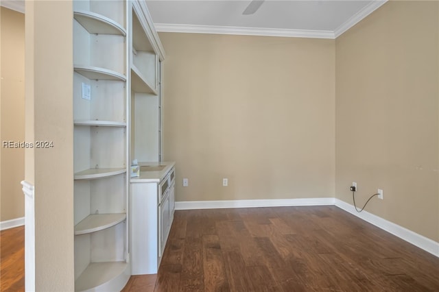 spare room with dark wood-type flooring, ornamental molding, and ceiling fan