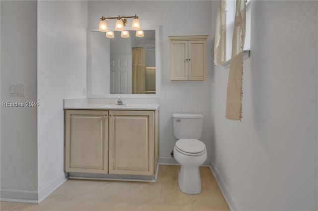 bathroom featuring vanity, a shower with shower curtain, tile patterned floors, and toilet