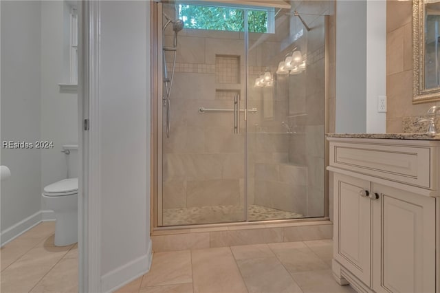 bathroom featuring tile patterned floors, toilet, an enclosed shower, and vanity