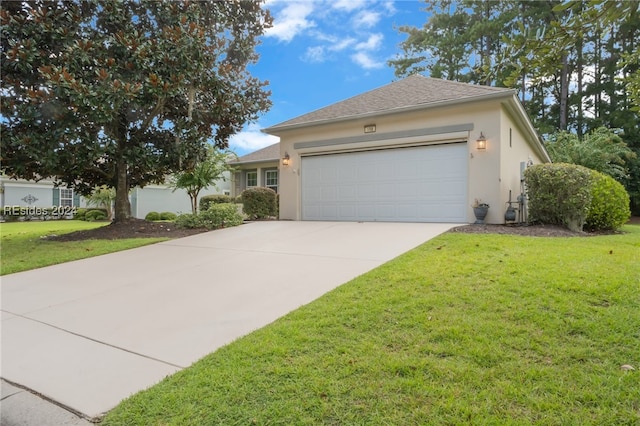 view of front of home featuring a garage and a front lawn