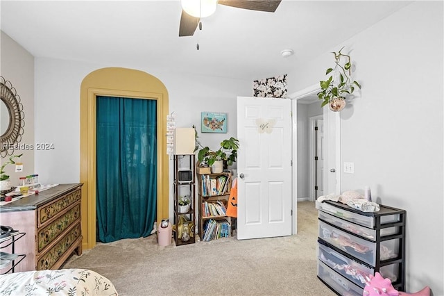 bedroom with ceiling fan and light colored carpet