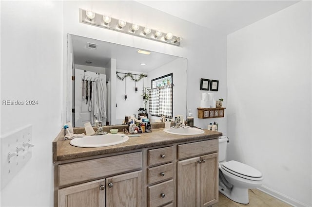 bathroom with vanity and toilet