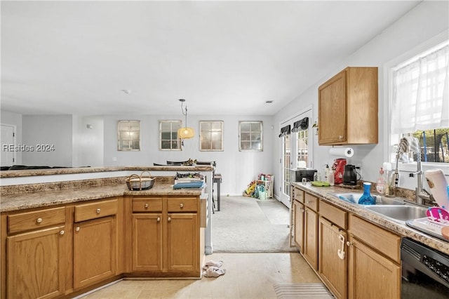 kitchen featuring pendant lighting, sink, and black dishwasher