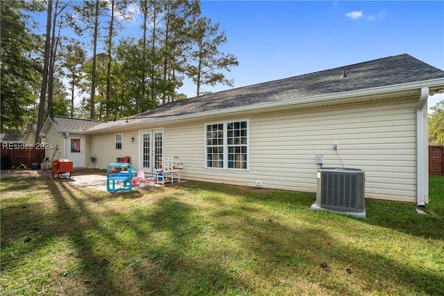 back of property featuring a yard, a patio area, french doors, and central air condition unit