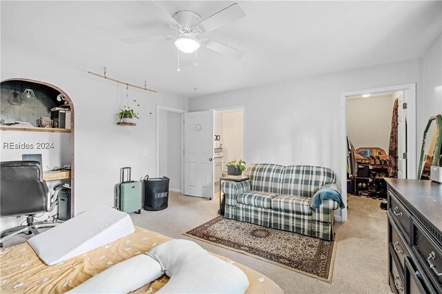 carpeted living room with ceiling fan