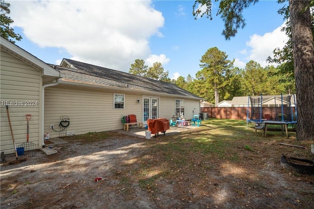 back of house with a patio, a trampoline, and french doors