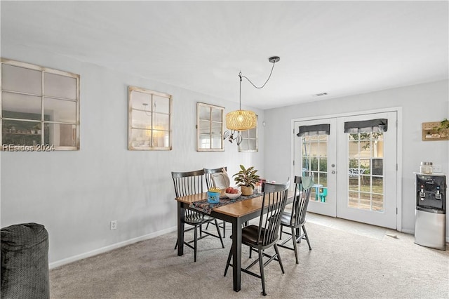 dining room with light carpet and french doors