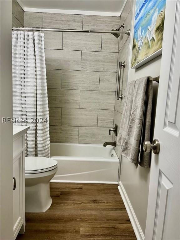 full bathroom with vanity, hardwood / wood-style floors, shower / tub combo, and toilet