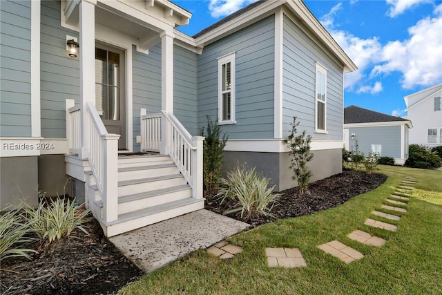 entrance to property featuring a yard