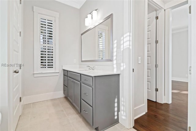 bathroom with crown molding, vanity, and tile patterned flooring