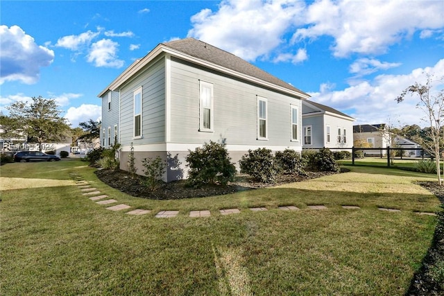 view of side of property featuring a yard