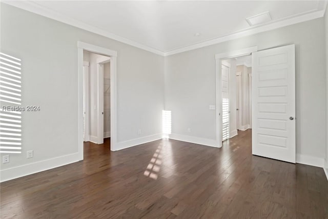 empty room featuring crown molding and dark hardwood / wood-style floors