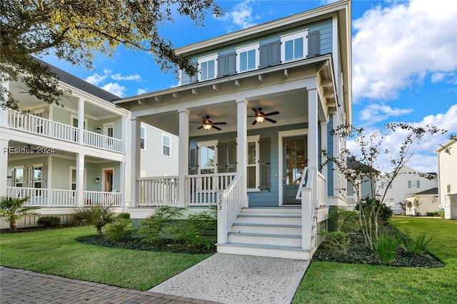 view of front of property with a porch, ceiling fan, and a front lawn